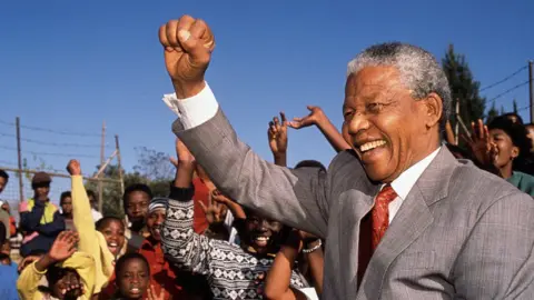 Getty Images Nelson Mandela visits Hlengiwe School to encourage students to learn