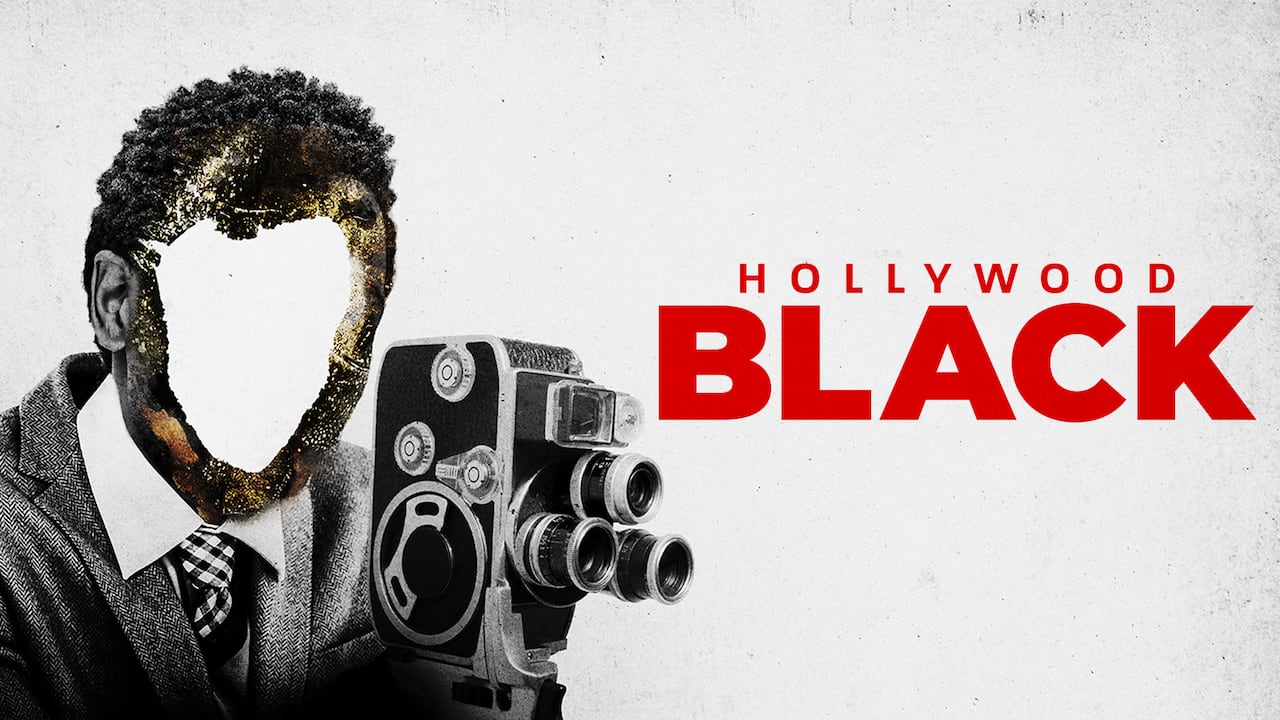 A man in a suit and tie with a white cutout over his face. He is holding an old-time film camera. To the right are the words: "Hollywood BLACK" in red text.