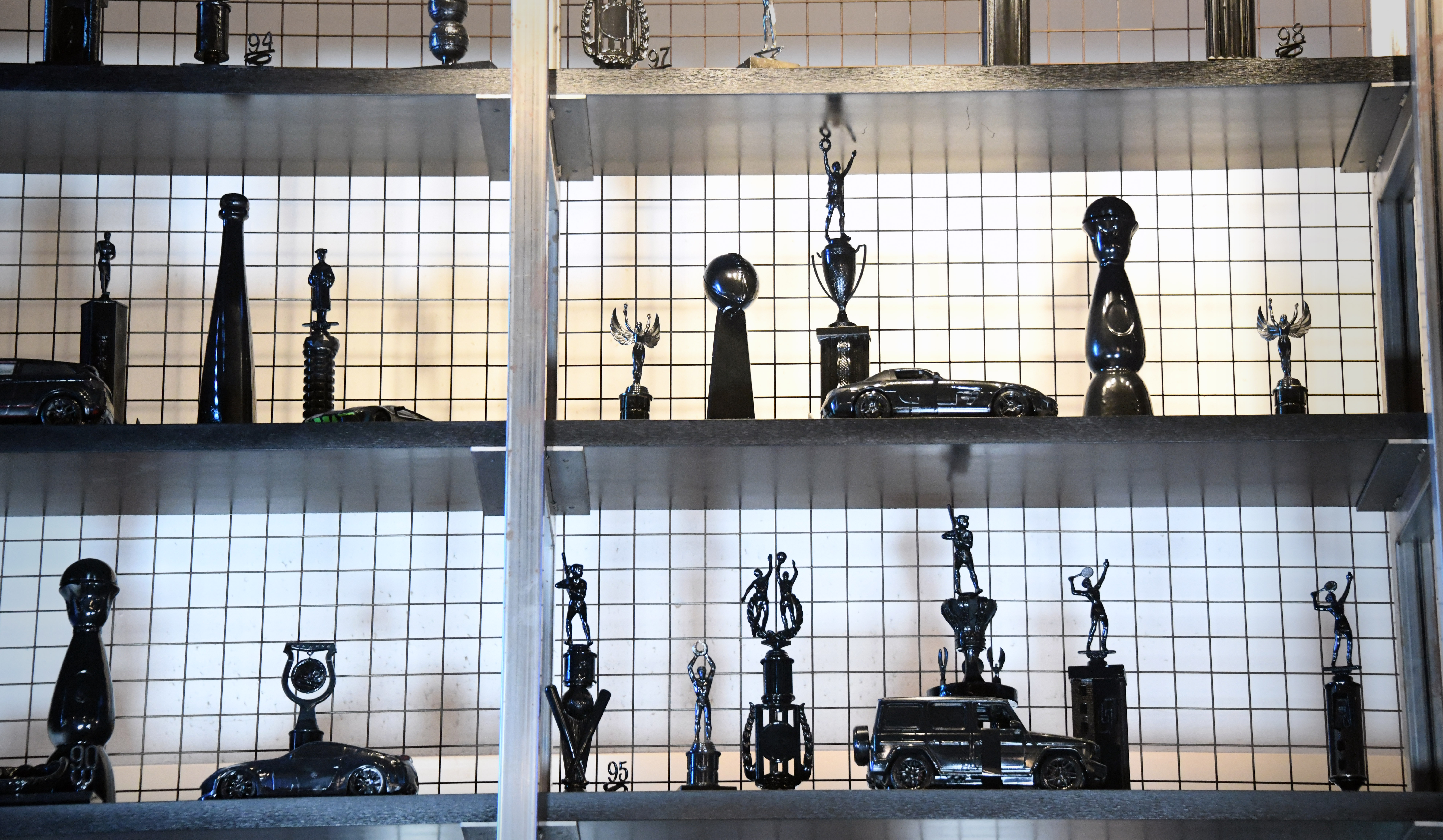 Black trophies are displayed over the kitchen at Blk Swan. Chris Simon, owner of the restaurant and bar in Harbor East, says the trophies highlight Black Excellence and promote discussion around it.